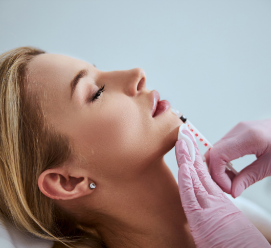 Practitioner applying lip filler treatment