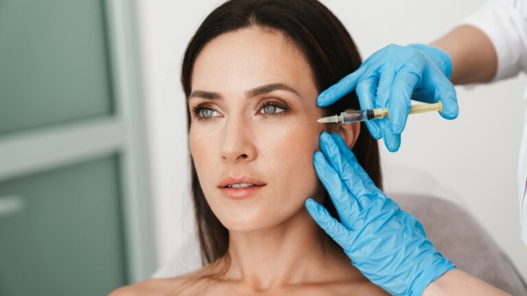 Patient receiving facial injection treatment near cheek area