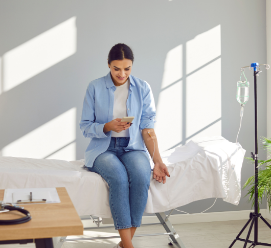 woman in hospital bed receiving IV therapy