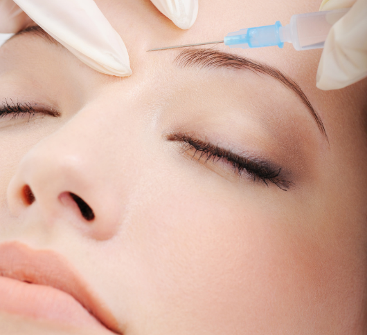 Woman receiving aesthetic facial treatment